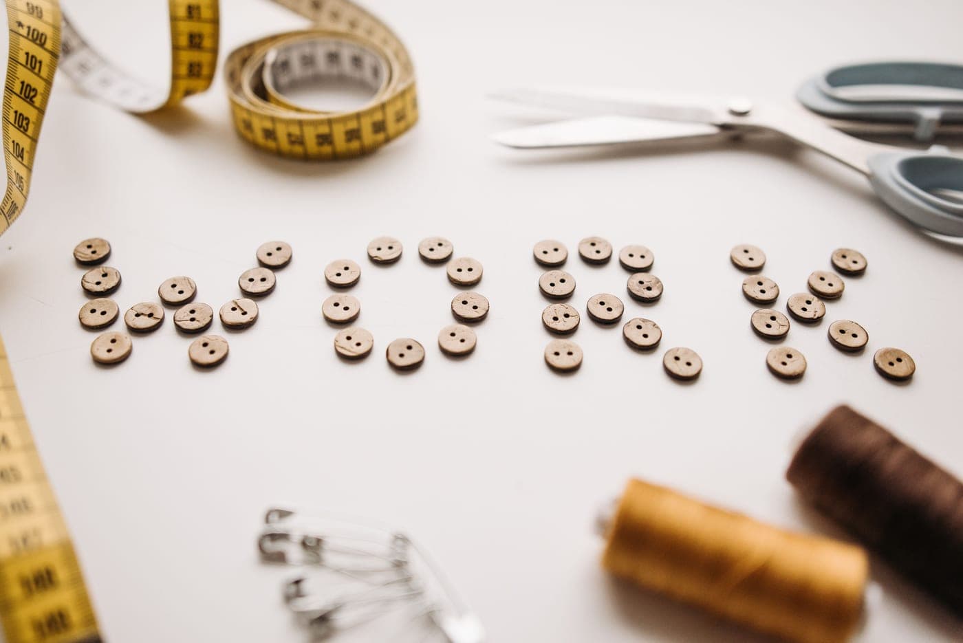 Buttons and sewing tools arranged on a surface