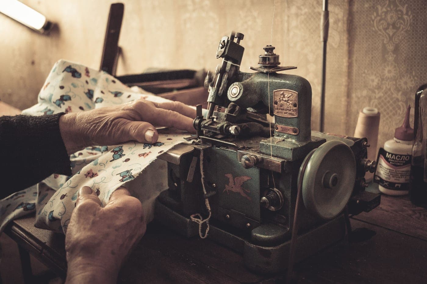 Close view of hands sewing on a machine