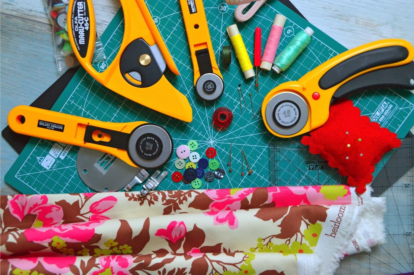 Cutting tools and a ruler laid out on a cutting mat