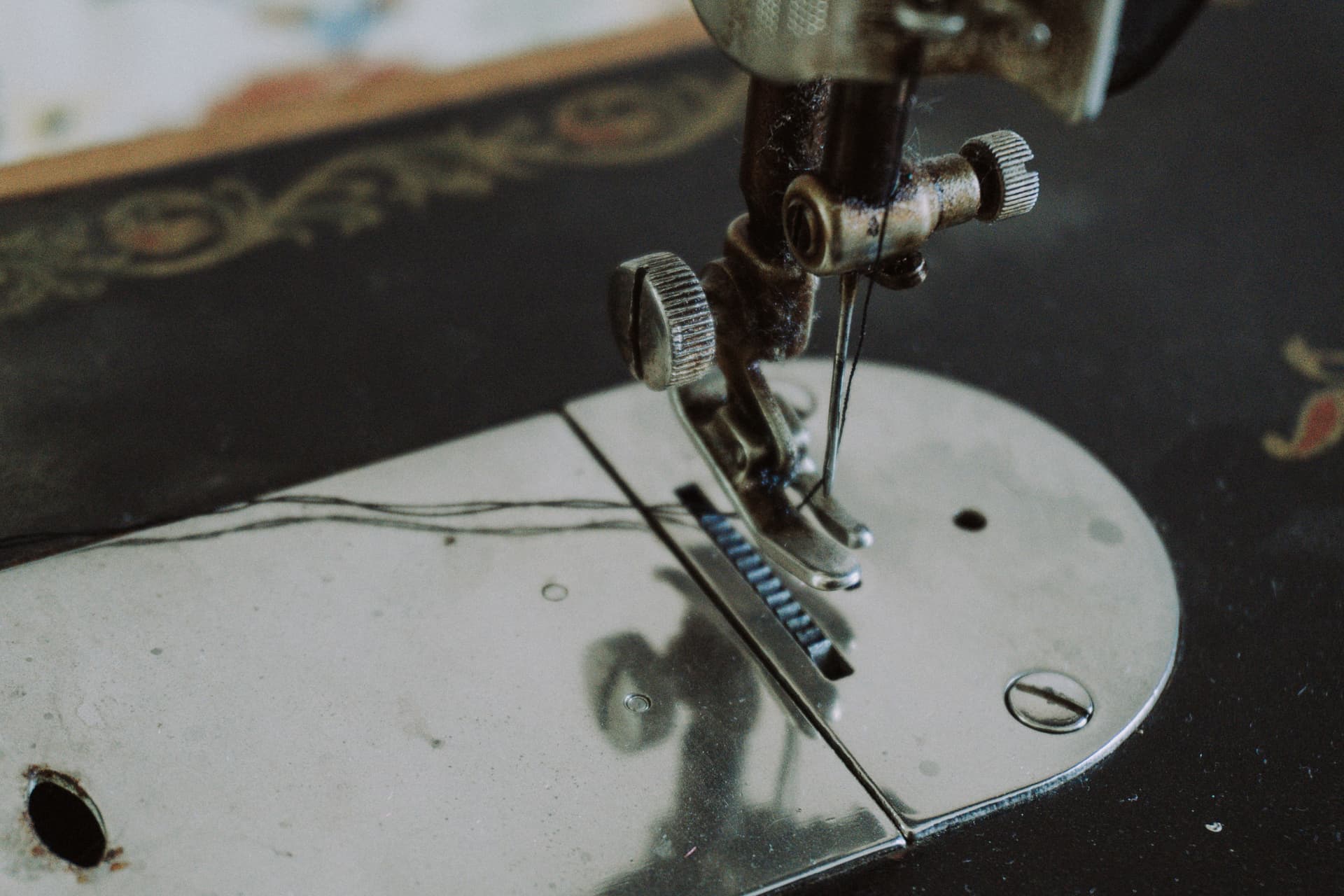 Close view of an antique sewing machine showing detailed metalwork