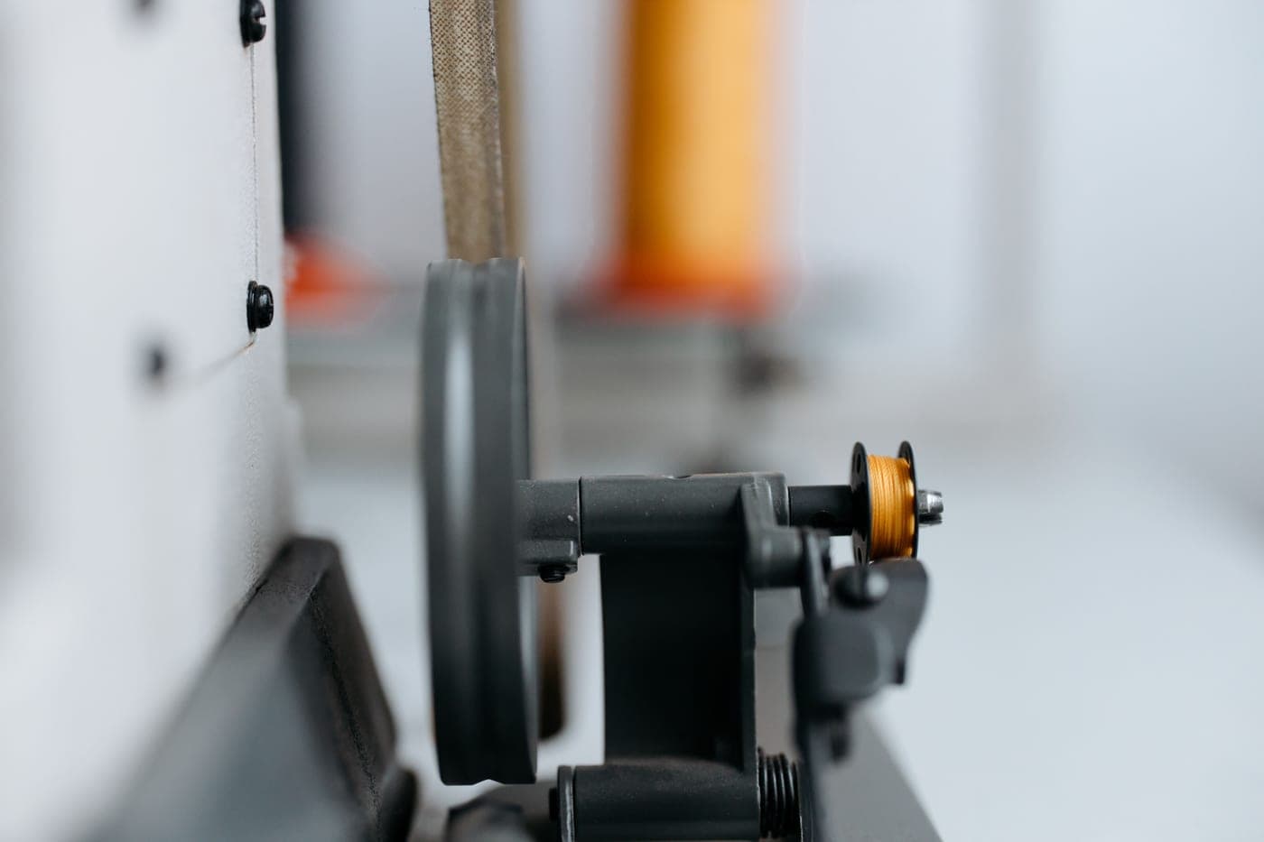 Close view of machinery with thread and a wheel