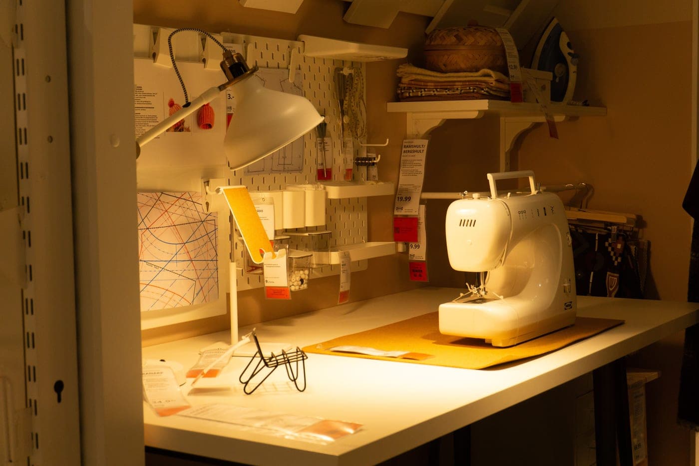 A sewing station with a machine, thread and fabric to hand