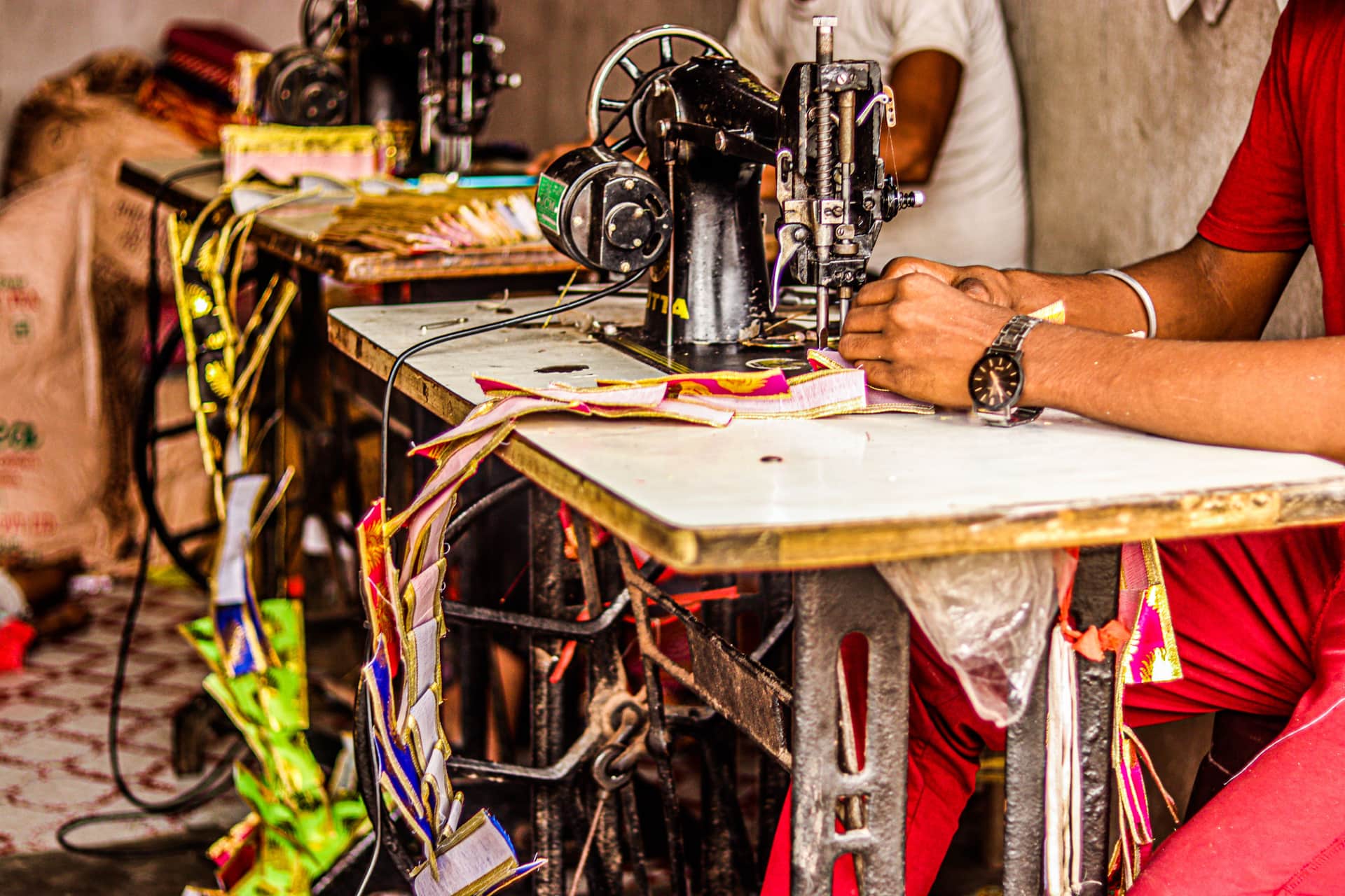 A person guiding fabric through a domestic sewing machine